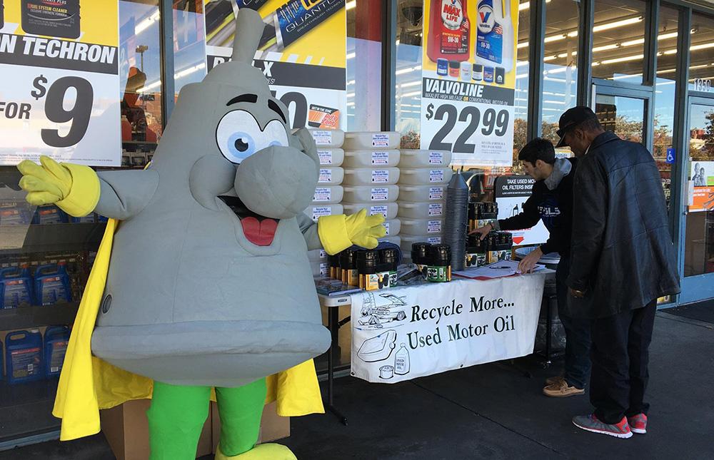 Mr. Funnelhead makes an appearance at an auto parts store to promote Use Oil Recycling