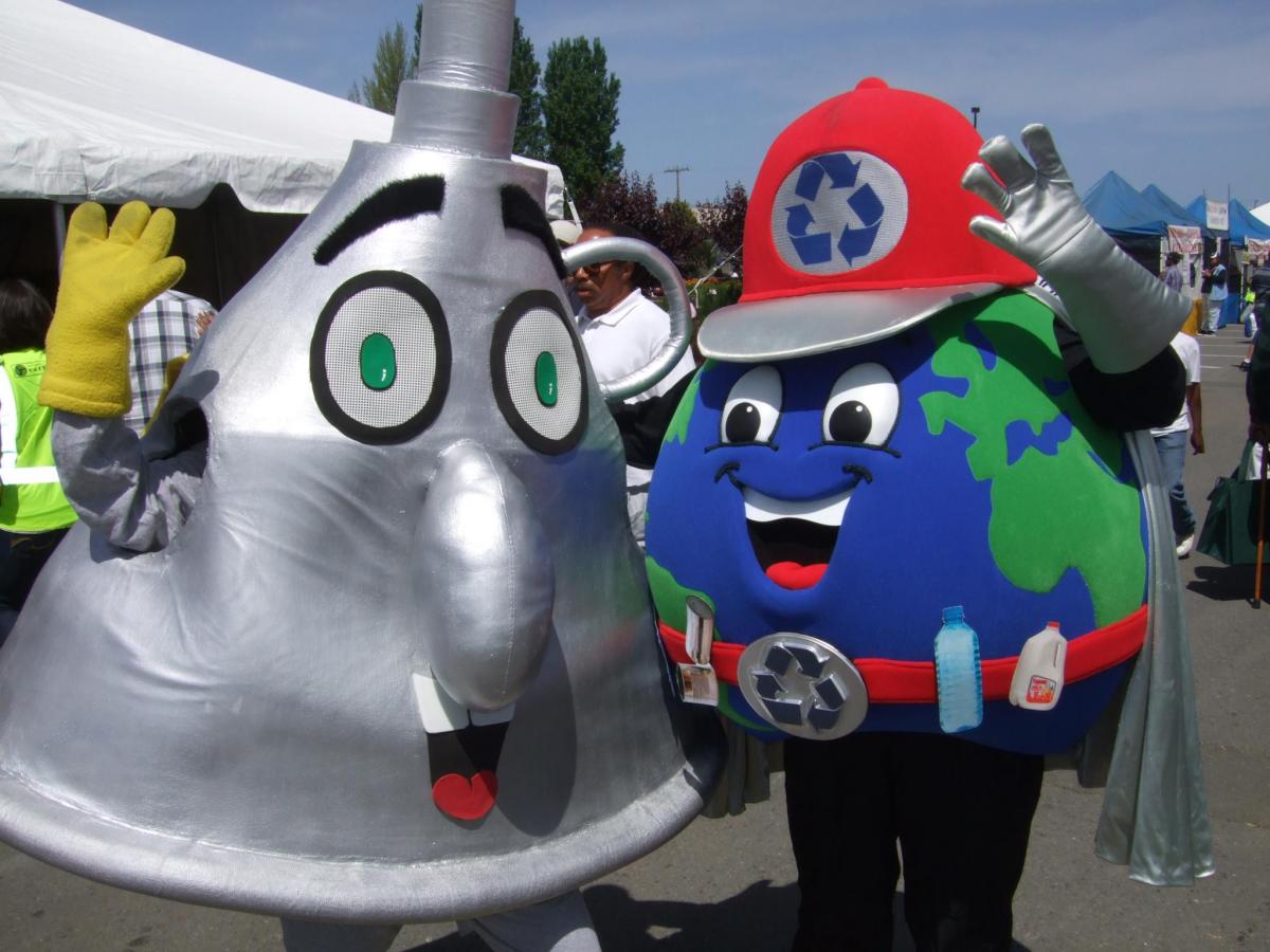 Mr. Funnelhead standing beside another character, the Earth with a recycle logo hat and belt.