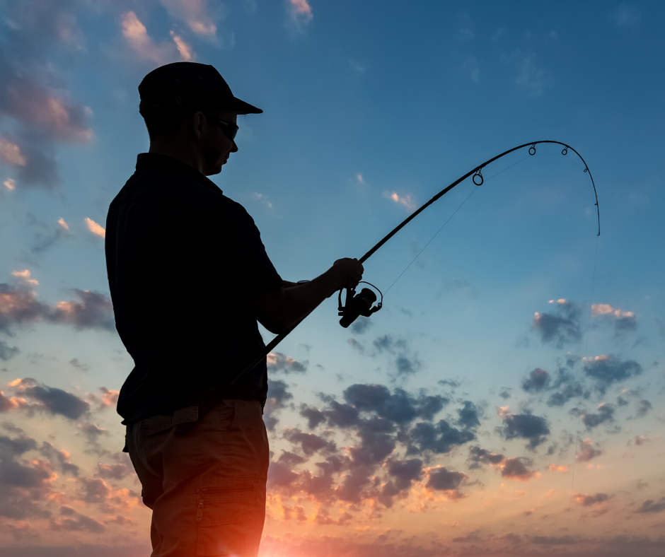 Fisherman casting at sunset