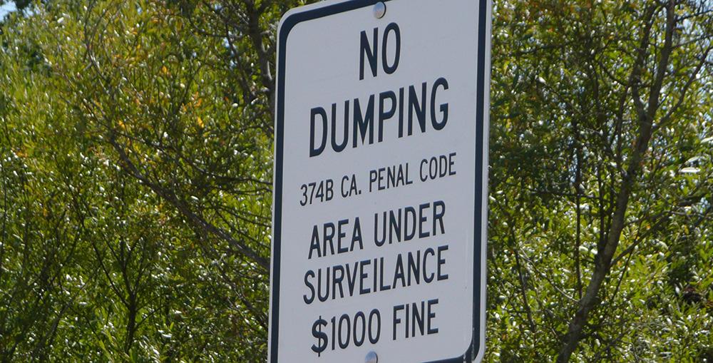 Sign showing "No Dumping, Area Under Surveillance"